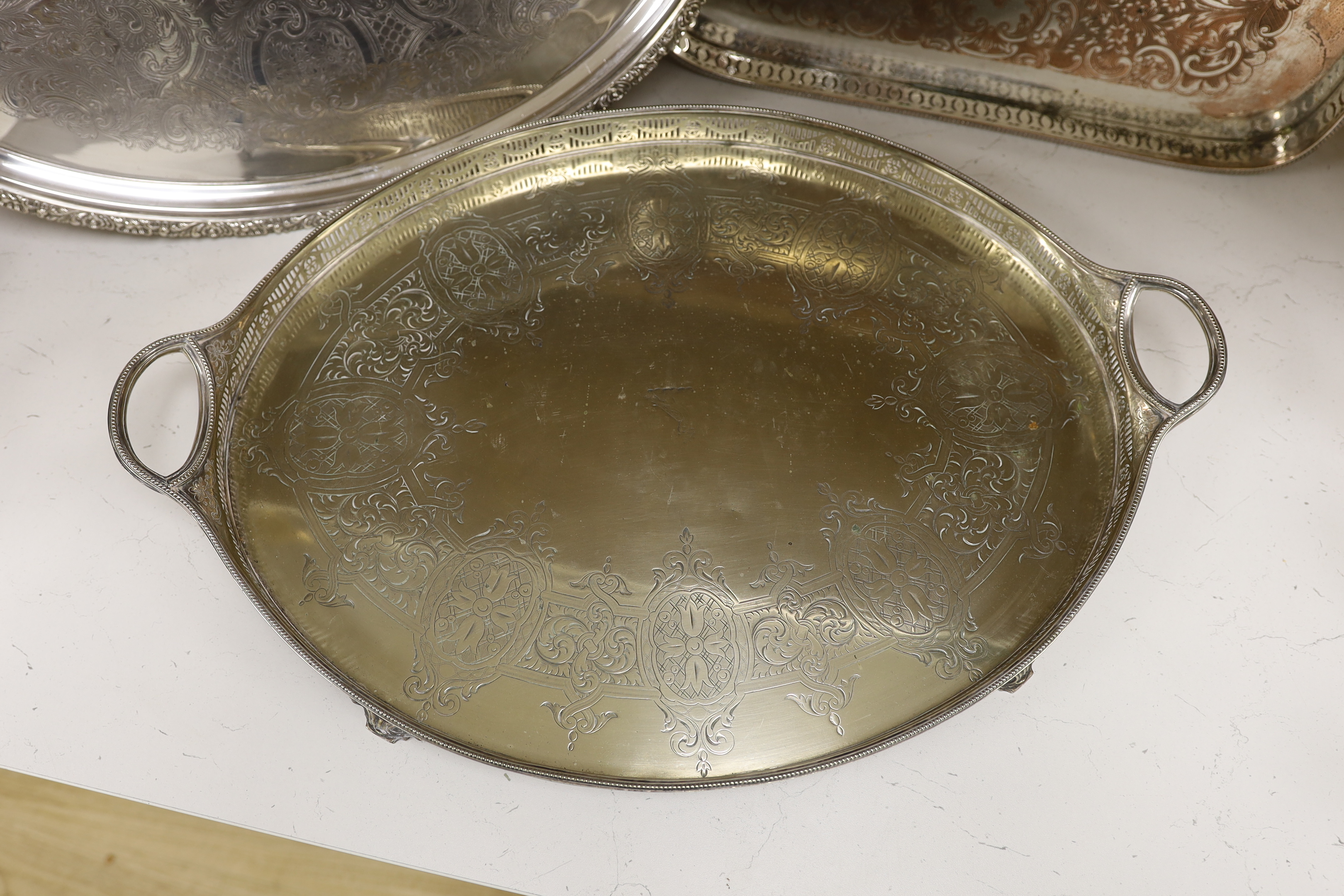 Four items of plated wares; a Victorian galleried tray, a soup tureen and two other trays, largest tray 67cm